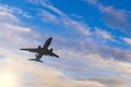 Airplane taking off at sunset. Silhouette of a big passenger or cargo aircraft, airline. Transportation Royalty Free Stock Photo