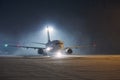 Airplane taxiing at airport during heavy snowfall Royalty Free Stock Photo