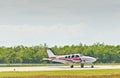 Airplane taxiing down tarmac of tropical airport