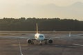 Airplane taxis in the terminal after landing evening light sunset Royalty Free Stock Photo