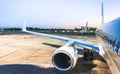 Airplane at terminal gate ready for takeoff at blue hour - Modern international airport with boarding aircraft on nighttime - Royalty Free Stock Photo