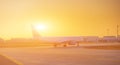 Airplane at the terminal gate ready for takeoff - Modern international airport during sunrise - Concept travel around the world Royalty Free Stock Photo