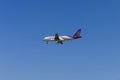 The airplane of Thai Smile Air is flying in blue sky Royalty Free Stock Photo