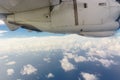 Airplane transport concept. View on the left wing passenger aircraft.Below the thick clouds illuminated by the sun.Horizontal view Royalty Free Stock Photo