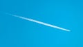 Airplane Vapor Trail Streaking Across a Blue Sky Royalty Free Stock Photo