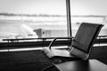 Airplane, view from airport terminal with empty seats in the airport waiting room near the gate. Travel concept with Royalty Free Stock Photo