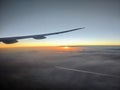 Airplane wing aerial view of sunset and clouds Royalty Free Stock Photo