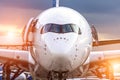 Airplane view from the front cockpit fuselage at sunset at the airport Royalty Free Stock Photo