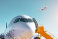 Airplane view from the front cockpit windshield fuselage and a passenger plane takes off in the sky at sunset light at the airport Royalty Free Stock Photo