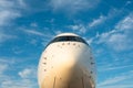 Airplane view from the front cockpit windshield fuselage at sunset light blue sky at the airport Royalty Free Stock Photo