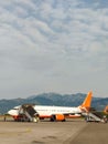 Airplane is waiting on board with mountains view. Plane landed