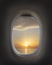 Airplane window with beautiful sky. Airplane window. Sea view, sunset and clouds. Travel and tourism concept. New scenic spots Royalty Free Stock Photo