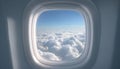 Airplane window with blue sky and clouds outside. Royalty Free Stock Photo