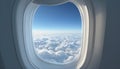 Airplane window with blue sky and clouds outside. Royalty Free Stock Photo