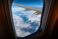 Airplane window from inside. Through the window you can see clouds and airplane wing. Royalty Free Stock Photo