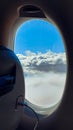 airplane window over clouds