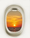 Airplane window with red sun. Airplane window. Sunset and clouds view. Travel and tourism concept. New scenic spots Royalty Free Stock Photo