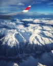 Airplane window view: airliner overflying the swiss-italian Alps