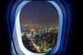 Airplane window view of bangkok city with night time. Concept of travel and air transportation Royalty Free Stock Photo