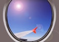 Airbus a380 airplane window view during a daytime flight above clouds with the sun and blue sky as the background Royalty Free Stock Photo