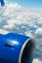Airplane window view over the clouds Royalty Free Stock Photo