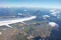 Airplane window view showing wing of the plane flying over small town city Royalty Free Stock Photo