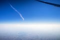 Airplane window view showing wing of a plane flying at sunrise Royalty Free Stock Photo