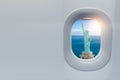 Airplane window with view on Statue of Liberty, New York, USA. Travel, tourism ando trip to USA concept