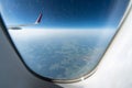 Airplane window view to cloudy sky and earth. Beautiful landscape from aircraft cabin. Flying without fear of flying, incidents