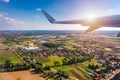 Airplane windows view above the earth on landmark down. View from an airplane window over a wing flying high above farmlands and Royalty Free Stock Photo