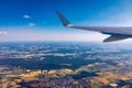 Airplane windows view above the earth on landmark down. View from an airplane window over a wing flying high above farmlands and Royalty Free Stock Photo