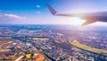 Airplane windows view above the earth on landmark down. View from an airplane window over a wing flying high above farmlands and Royalty Free Stock Photo