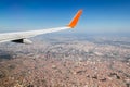 A airplane wing above the ground with beautyful landscape