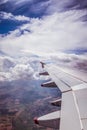 Airplane wing through the aircraft window. Greenhouse effect, global warming Royalty Free Stock Photo