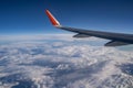 Airplane wing, blue sky and many white clouds. Incredible height. Travel abroad. Tourism. Royalty Free Stock Photo