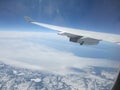 Airplane wing blue sky white clouds earth view Royalty Free Stock Photo