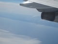 Airplane wing blue sky white clouds earth view Royalty Free Stock Photo