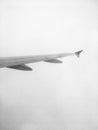 Airplane wing in the clouds black and white