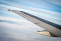 Airplane wing through the clouds