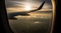 Airplane Wing and Engine Seen Through a Window During Sunset Flight Above Clouds image photo Royalty Free Stock Photo