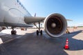 Airplane wing with engine, view under the plane during flight service