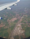 Airplane wing, express higway road nd fields aerial view from aeroplane window Royalty Free Stock Photo