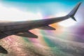 airplane wing in flight above clouds with optical effect Royalty Free Stock Photo