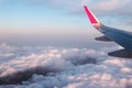 Airplane wing on a flight above the clouds during the sunset Royalty Free Stock Photo