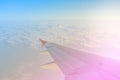 Airplane Wing in Flight from window above clouds and sky. Royalty Free Stock Photo