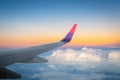 Airplane Wing in Flight from window, sunset sky, twilight sky Royalty Free Stock Photo