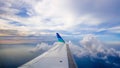 Airplane wing fly on the sky full of clouds. It was taken on sunny day almost sunset Royalty Free Stock Photo