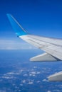 Airplane wing flying in the blue sky Royalty Free Stock Photo