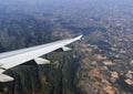 Airplane wing flying over land Royalty Free Stock Photo