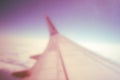 Airplane wing while flying in the rays of the rainbow, retro photo style Royalty Free Stock Photo